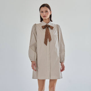 Model wearing the Marguerite striped bow tie shirt dress, front view